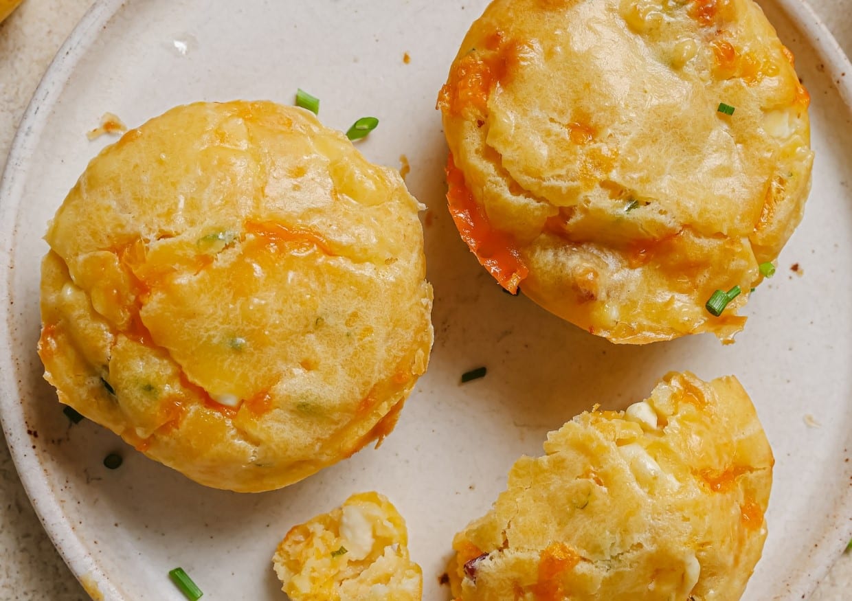 Cottage cheese breakfast muffins on a plate with green onions.