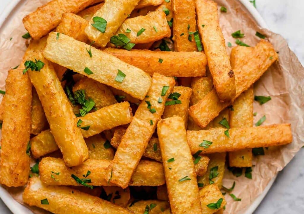French fries on a plate with parsley.