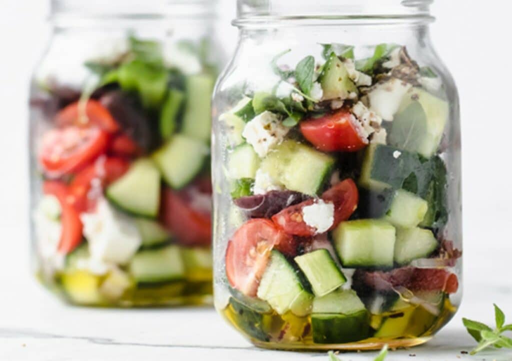 Greek cucumber salad in mason jars.