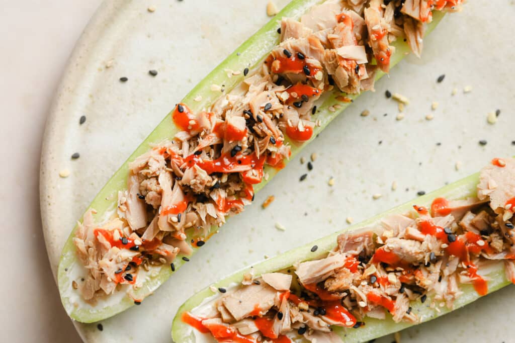 Two cucumber rolls with tuna and sesame seeds.
