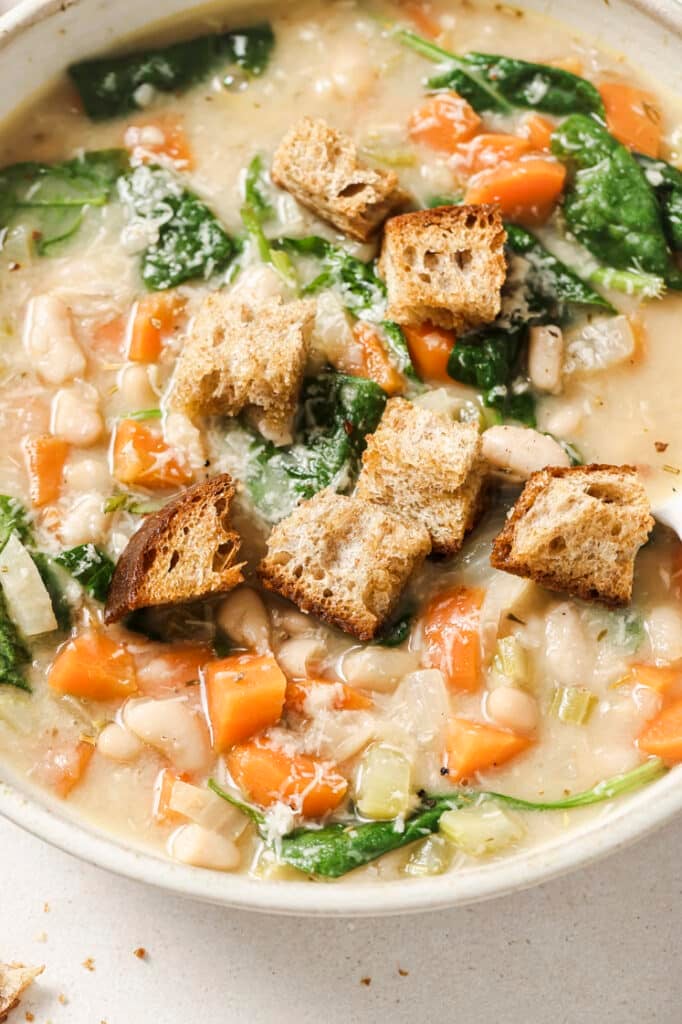 White bean soup with croutons in a bowl.