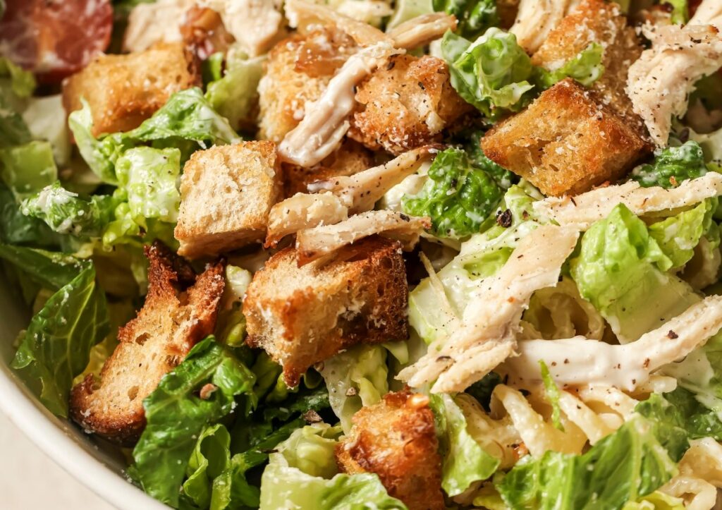 Chicken Caesar pasta salad with croutons.