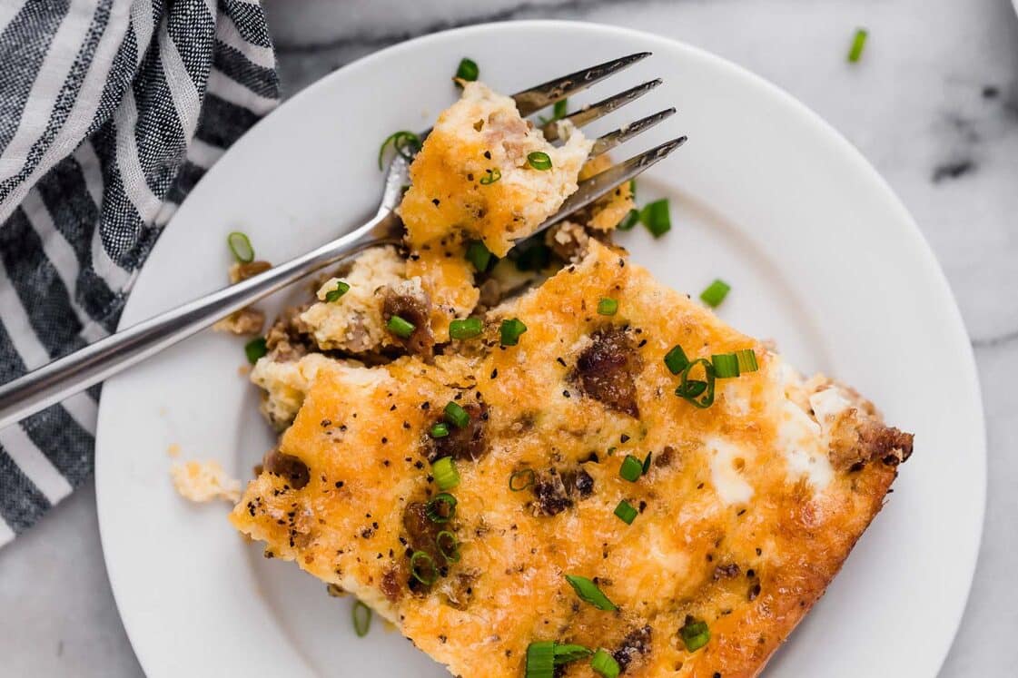 Sausage breakfast casserole on a plate with a fork.