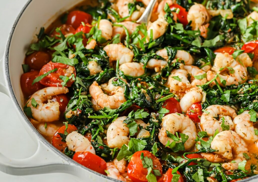 Tuscan garlic shrimp and spinach in a pan.