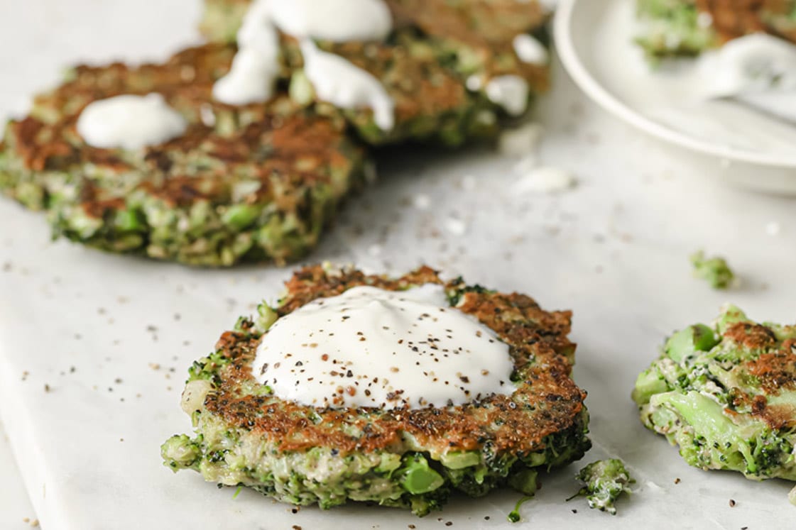 A stack of broccoli fritters on a plate.
