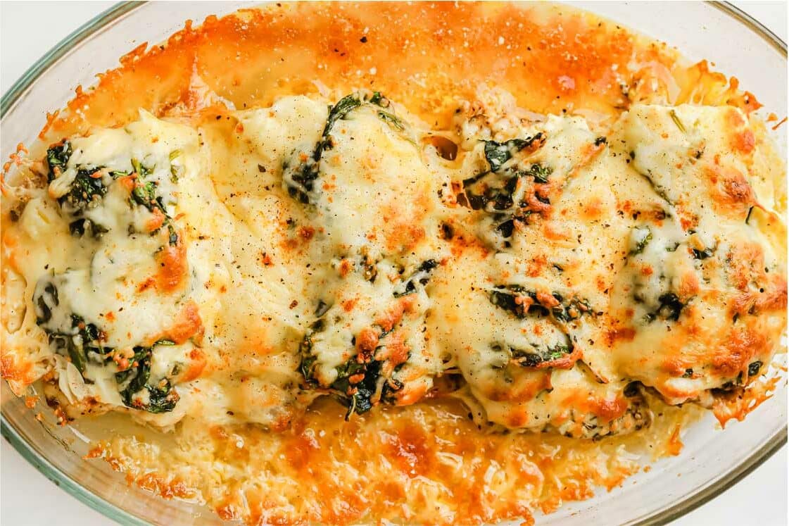 Creamy spinach chicken bake in a casserole dish.