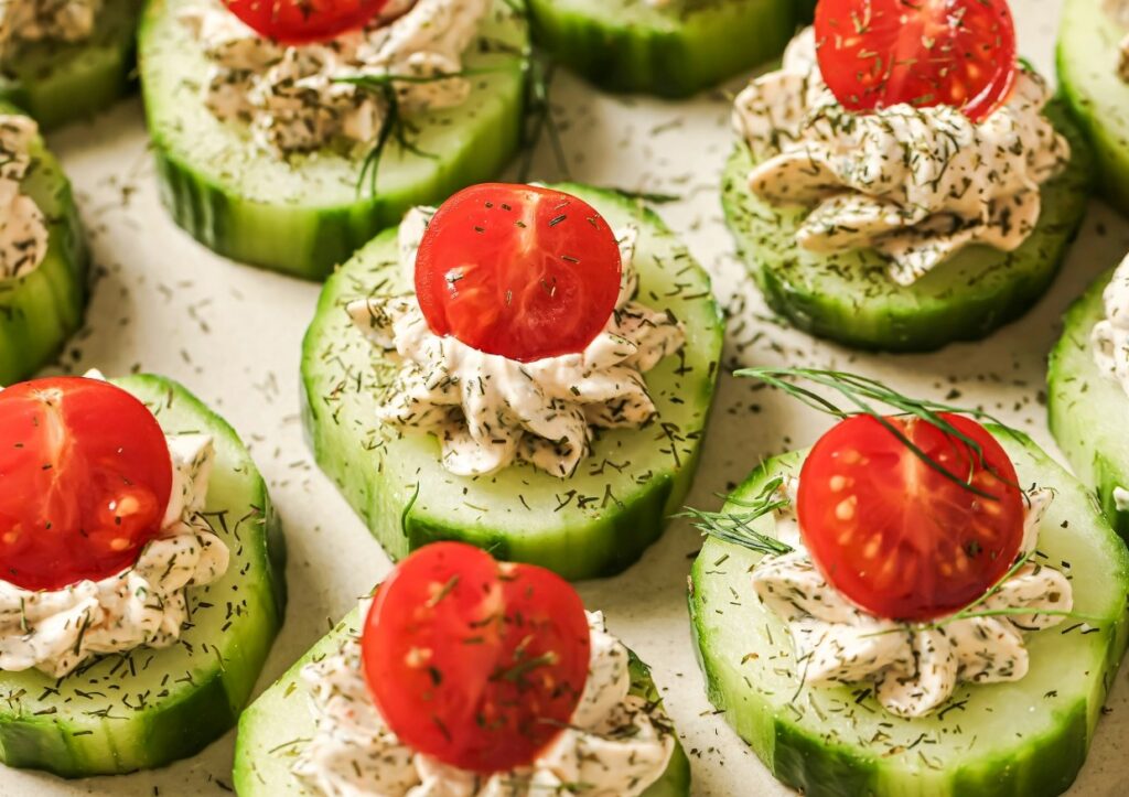 Cucumber tomato bites garnished with dill.