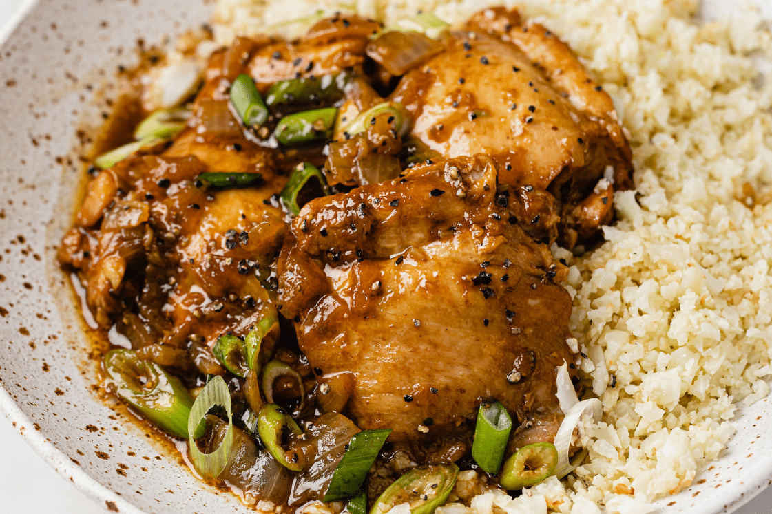Instant Pot chicken adobo with cauliflower rice on a plate.