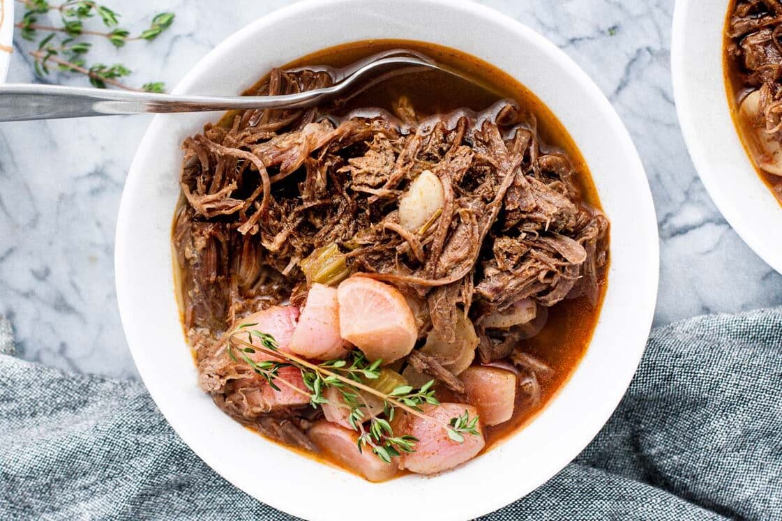 Keto pot roast freezer meal in a bowl with a spoon.