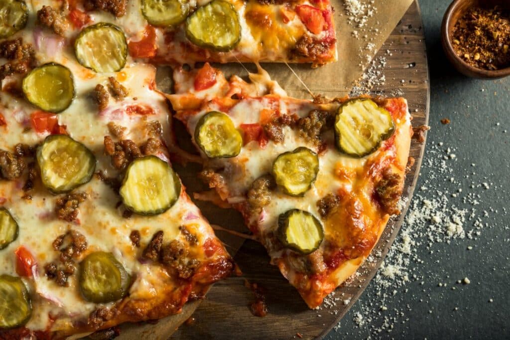 Slices of pickles on pizza.