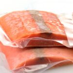 Stacked frozen salmon filets.