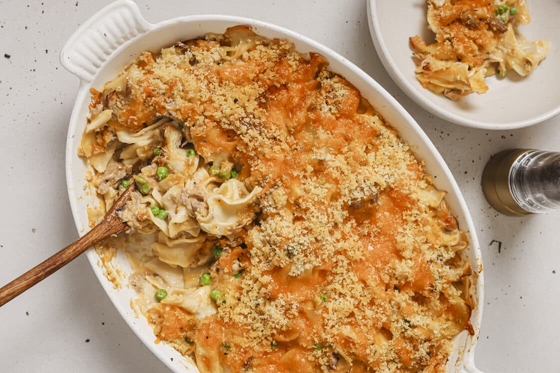 Easy tuna noodle casserole with a wooden spoon in a baking dish.