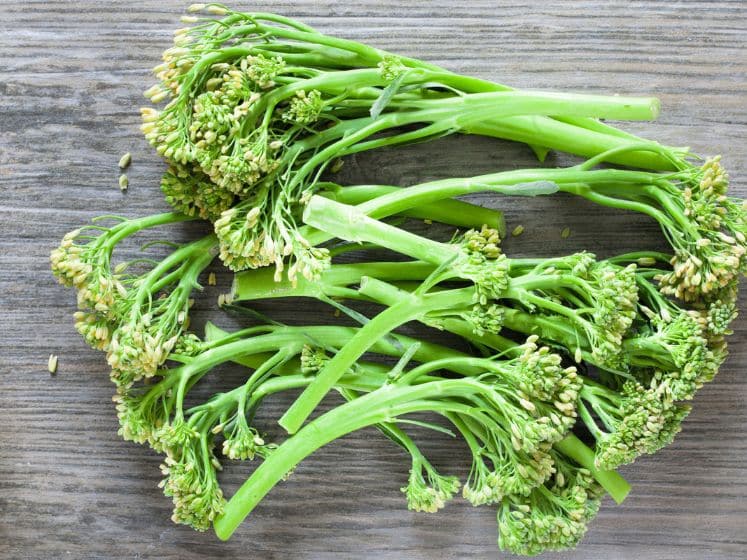 Fresh broccoli stems on a wood surface