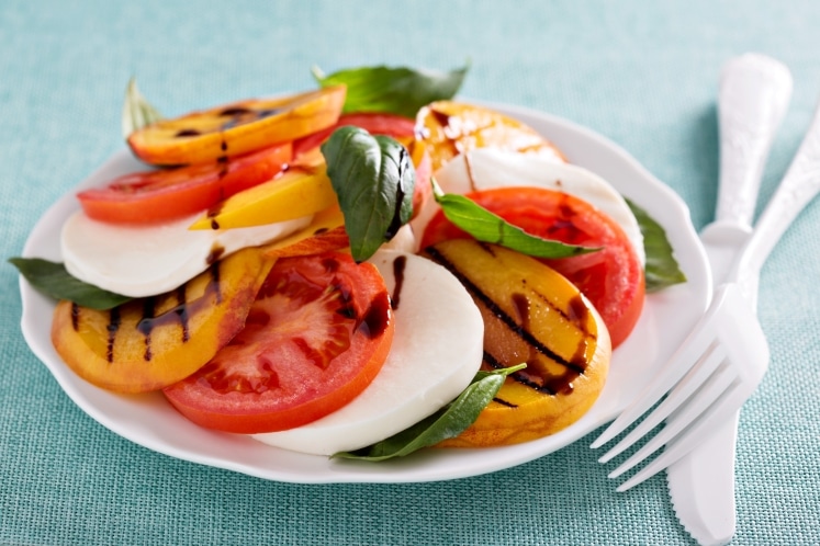 Grilled caprese salad on a plate.