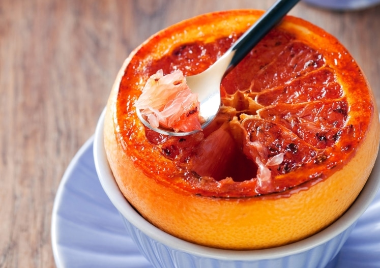 Grapefruit with a spoon.