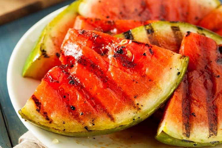 Grilled watermelon on a plate.