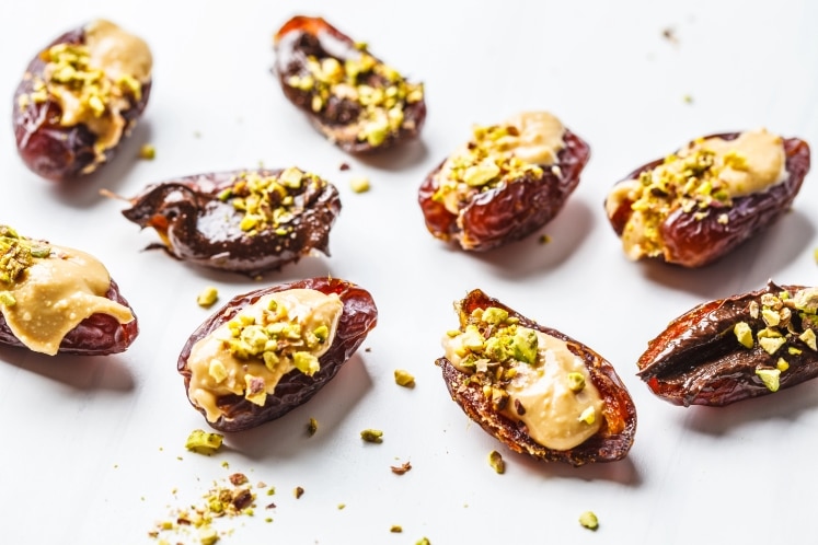 Dates stuffed with peanut butter and pistachios.