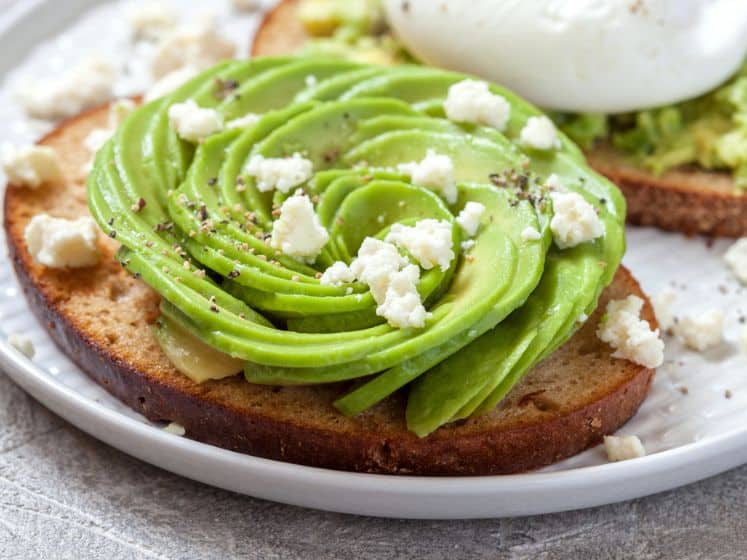 Healthy breakfast toasts with avocado and poached egg