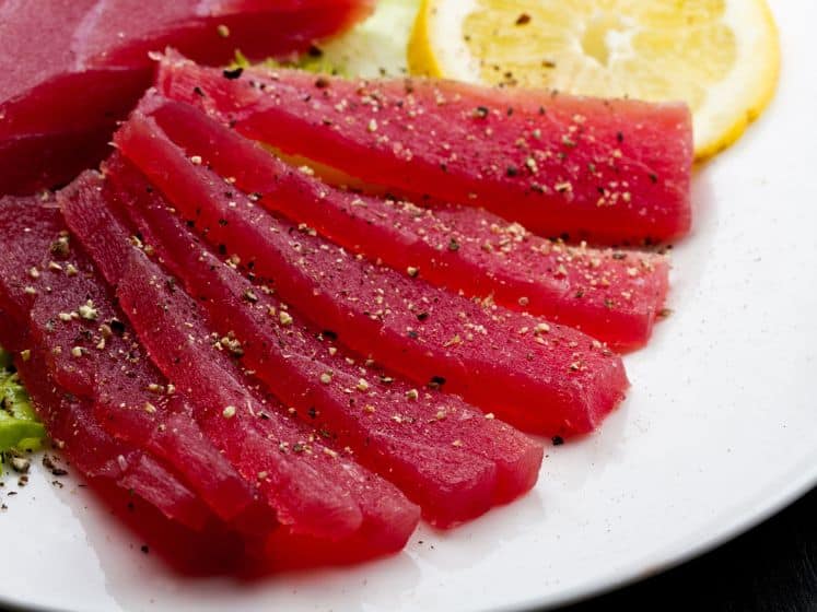 Slices of raw bluefin tuna sashimi on white dish