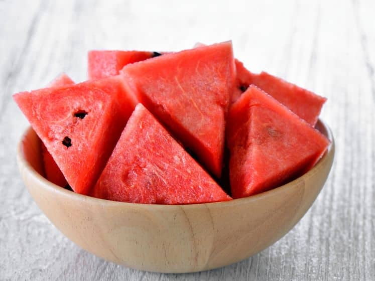 Water melon in wood bowl on table