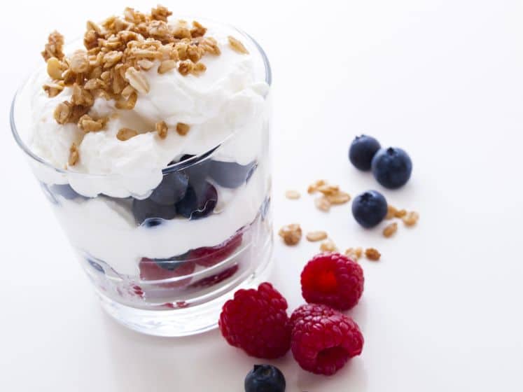 Delicious fruit, Greek yogurt and granola parfaits on white