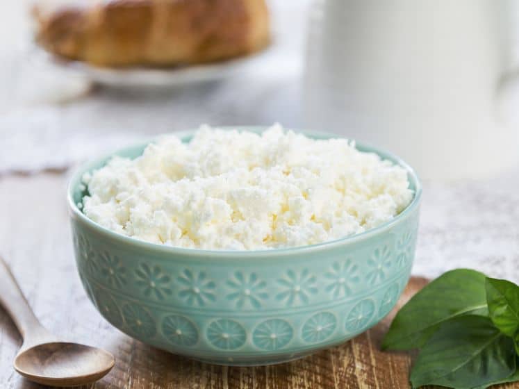 Ricotta cheese in a green bowl