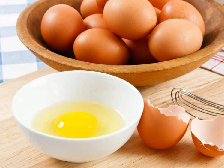 Cracked whole egg in a bowl