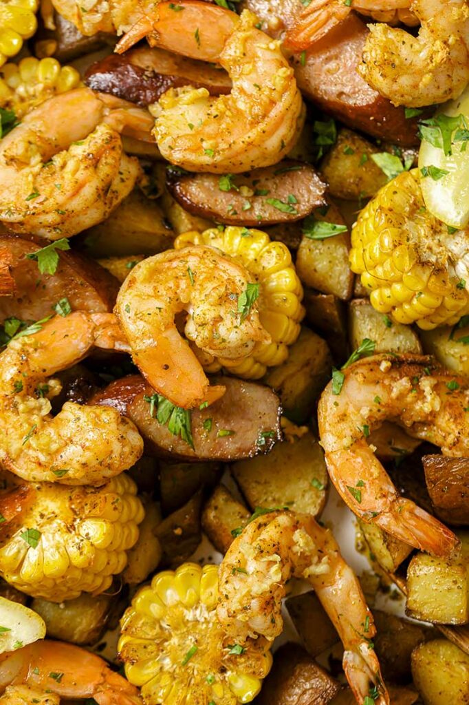 Garnished sheet pan shrimp boil on a sheet pan.