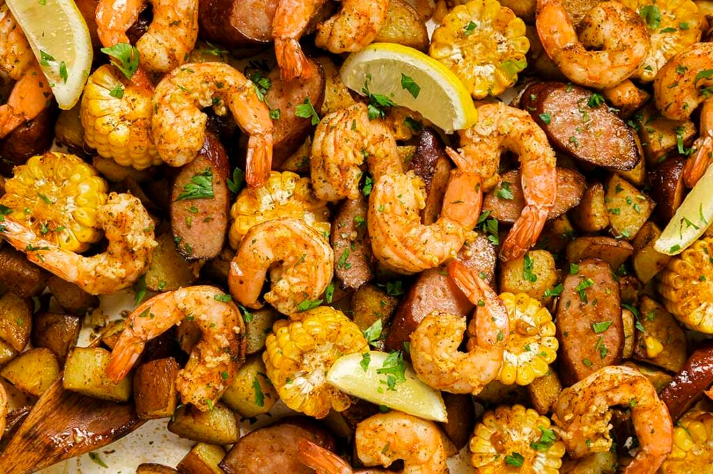 Garnished sheet pan shrimp boil on a sheet pan.