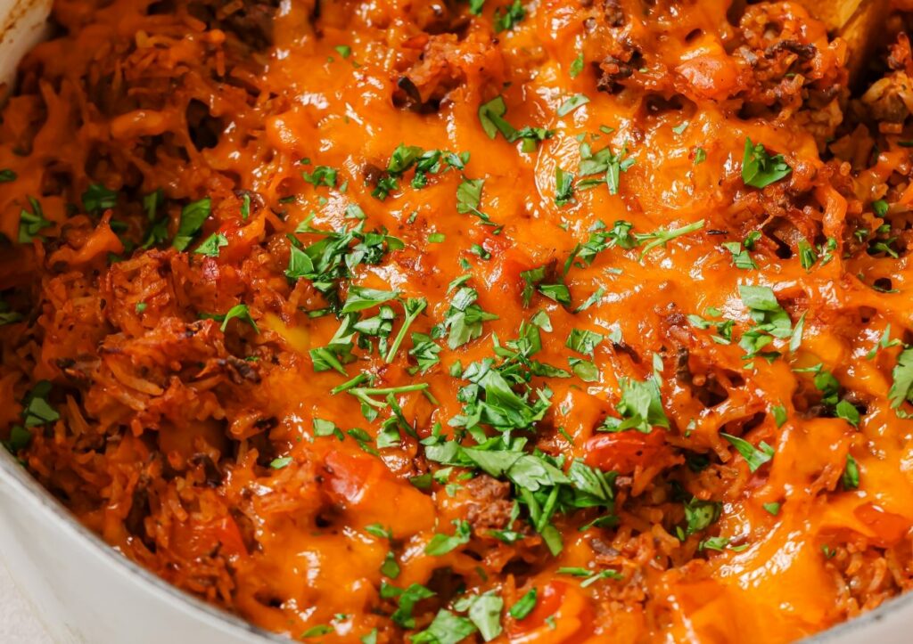 Stuffed bell pepper casserole garnished with fresh herbs.