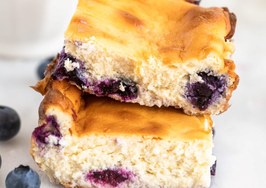 A stack of two blueberry cheesecake bars.