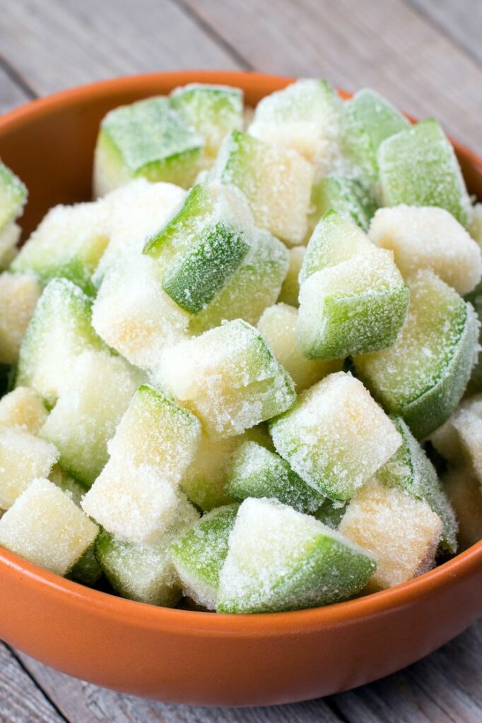 Frozen zucchini cubes in a bowl.