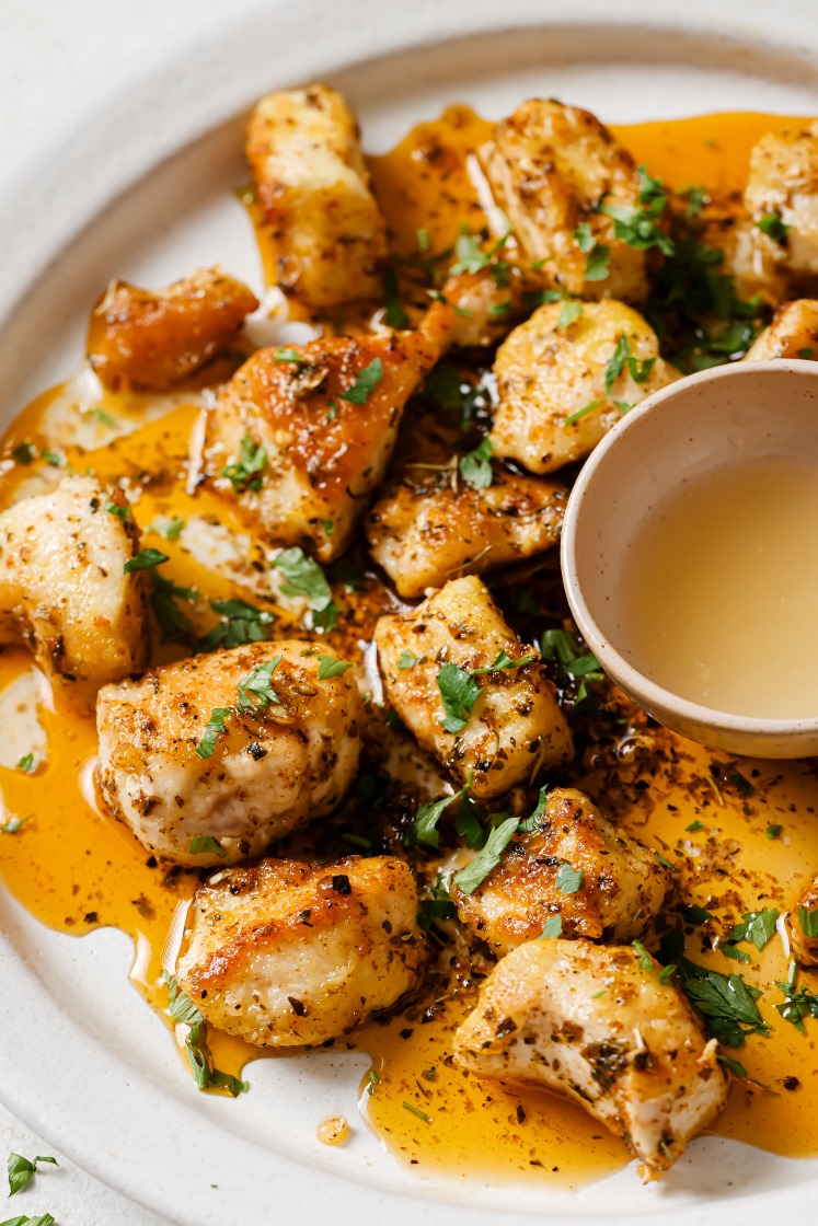 Garlic butter chicken bites on a plate.