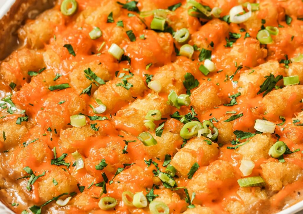 A chicken tater tot casserole topped with green onions.