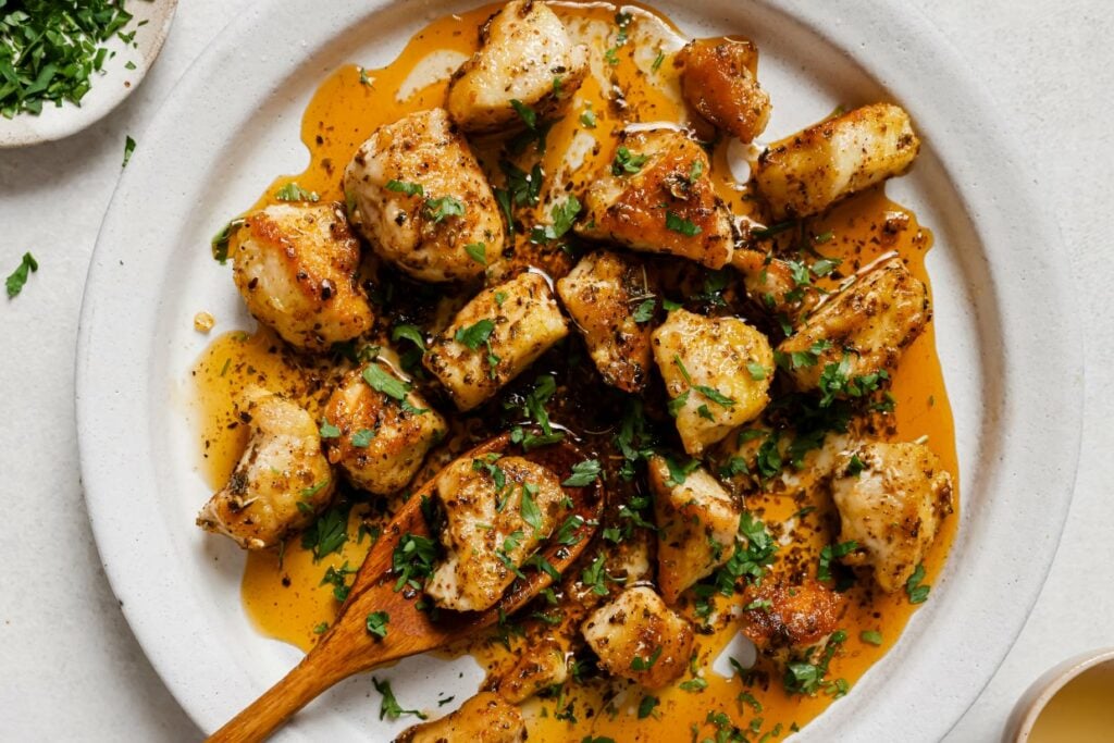 Garlic butter chicken bites on a plate.