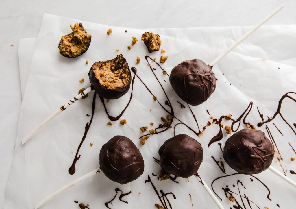 Keto pumpkin pie cake pops on a baking sheet.