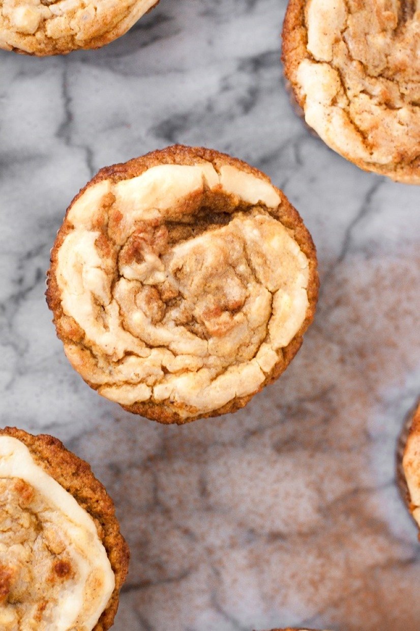 Some low-carb cream cheese pumpkin muffins on a marble countertop.