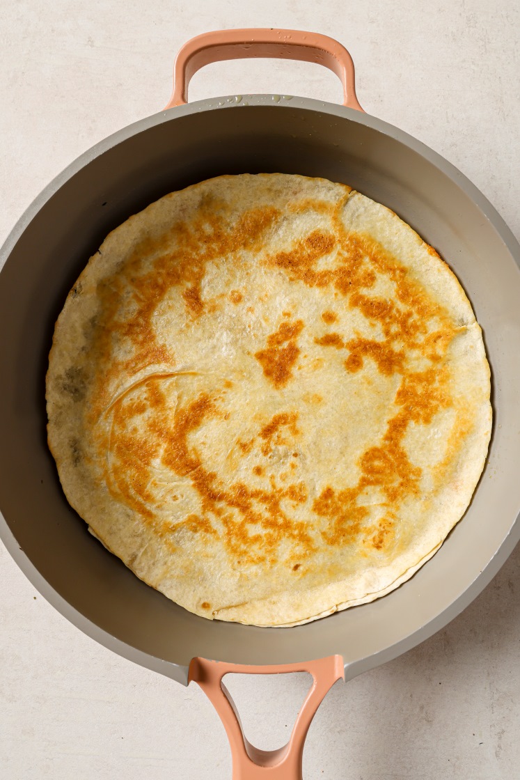 A tuna melt quesadilla in a pan.