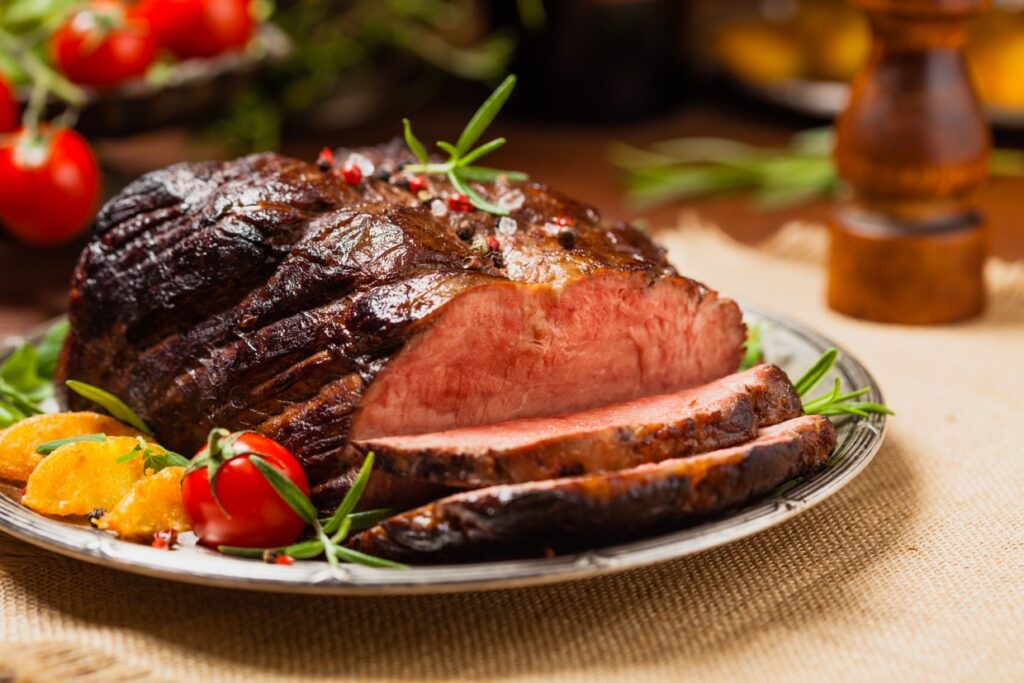 Sliced beef brisket on a serving tray.