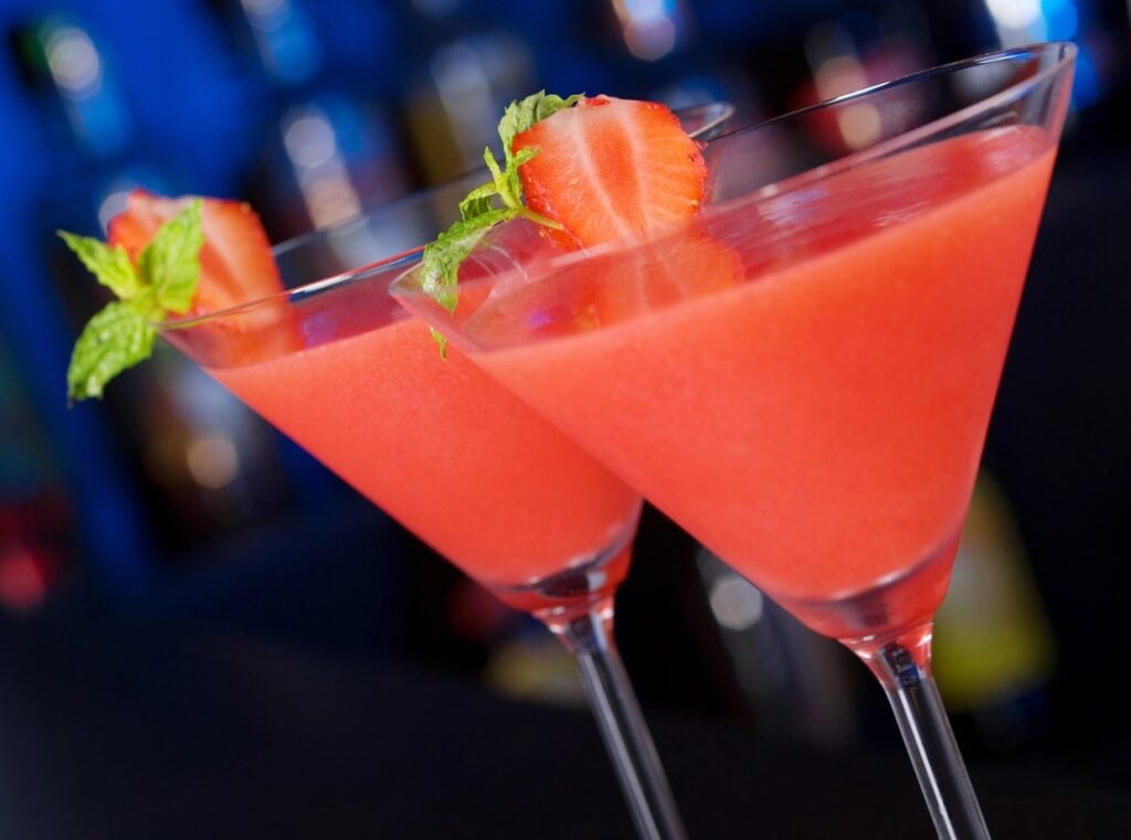 Strawberry daiquiri garnished with sliced strawberries.