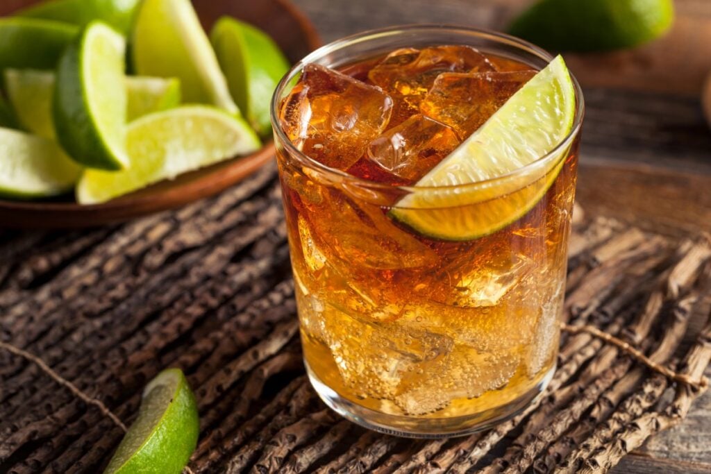 Dark 'n' Stormy cocktail garnished with a lime wedge.