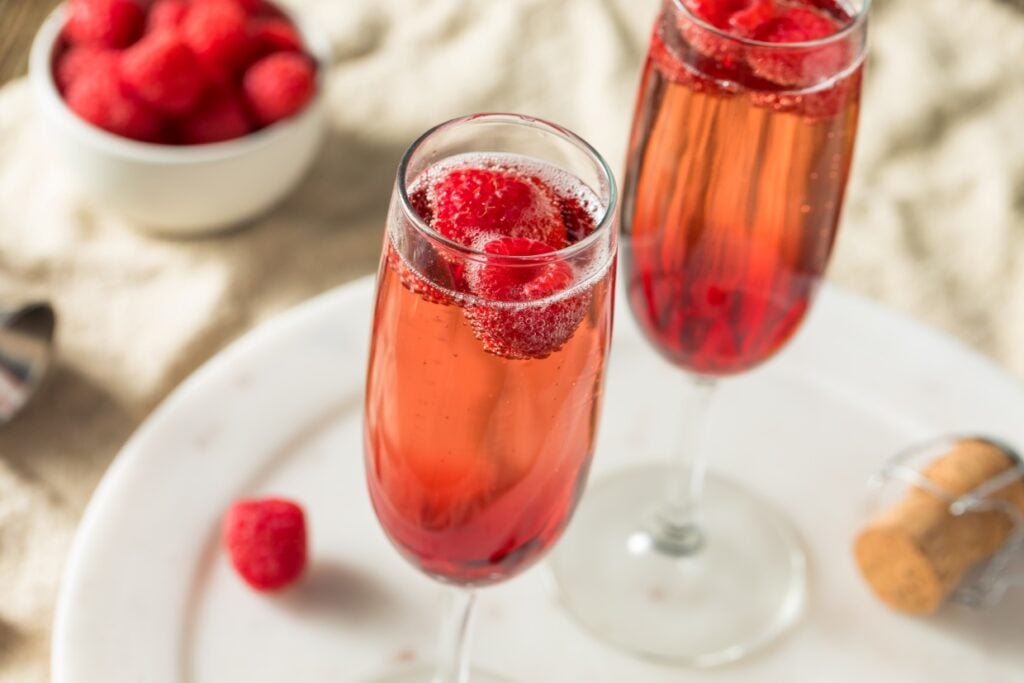 Kir cocktails with fresh raspberries.