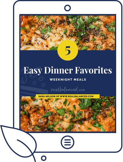 Tablet displaying a cookbook cover titled "5 Easy Dinner Favorites: Weeknight Meals" by Sara Nelson from realbalanced.com. The cover features images of colorful, herb-topped dishes.