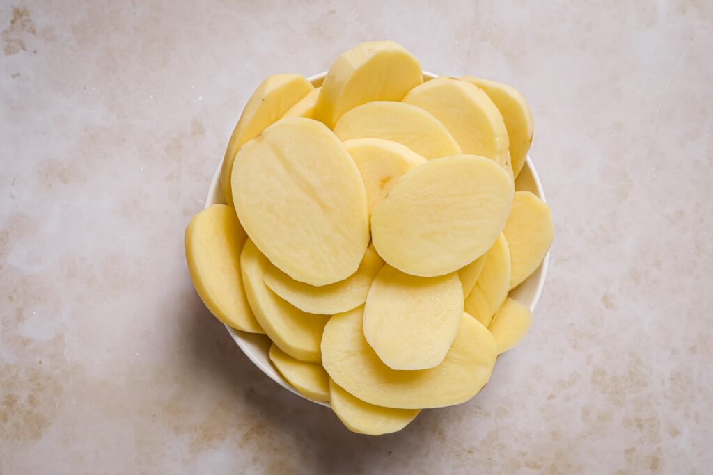 A bowl of sliced potatoes.