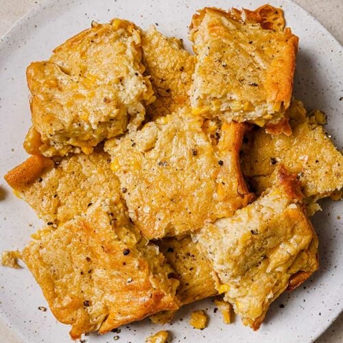 A plate of Jiffy corn casserole slices, seasoned with black pepper.