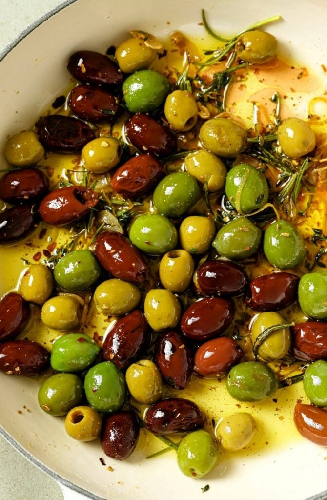 A pan of warm marinated olives.