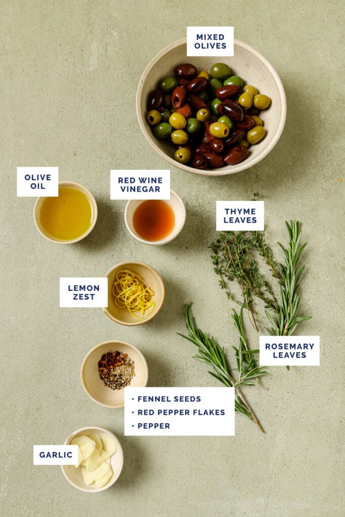 Labeled ingredients for the warm marinated olives recipe.