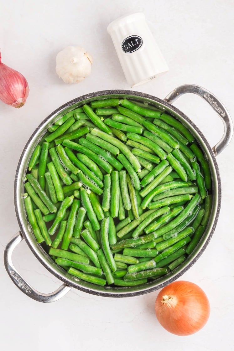 A pot of green beans and onions.