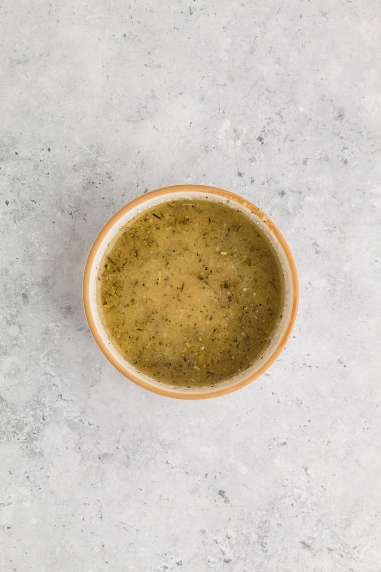 Garlic parmesan butter mixture prepared in a bowl for air fryer chicken skewers.