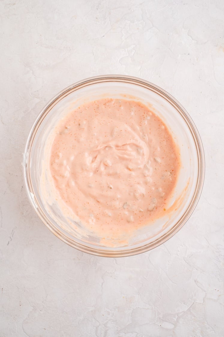 Glass bowl filled with creamy pink animal-style sauce made from mayo, ketchup, relish, and seasonings.